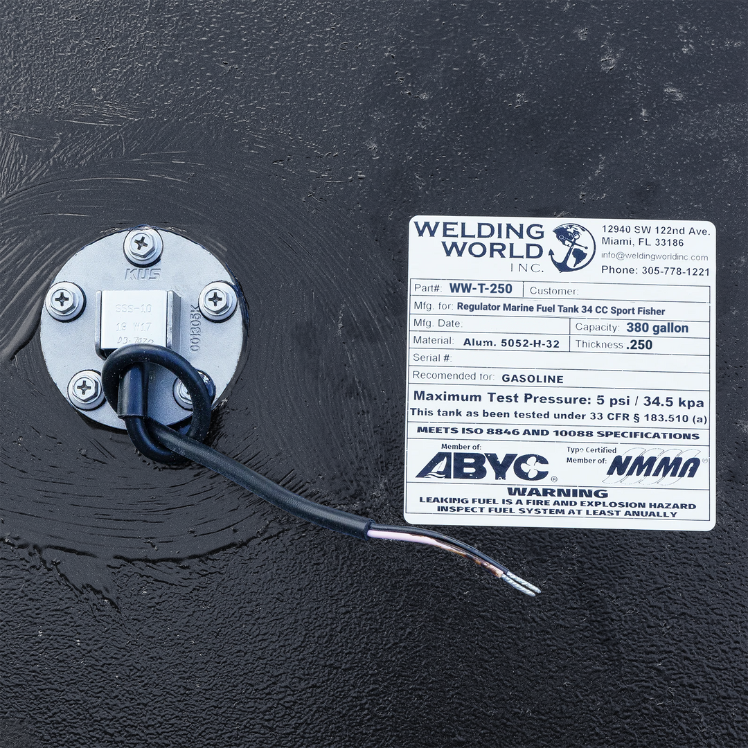 Close-up of an official manufacturer data plate and KUS fuel sending unit on a Regulator 34 CC Sport Fisher replacement fuel tank. The label confirms a 380-gallon capacity, heavy-duty .250" 5052-H32 aluminum construction, and compliance with ABYC, NMMA, and USCG (33 CFR § 183.510) standards. The high-build Coal Tar Epoxy finish ensures a guaranteed OEM fit and maximum corrosion resistance for offshore marine environments.