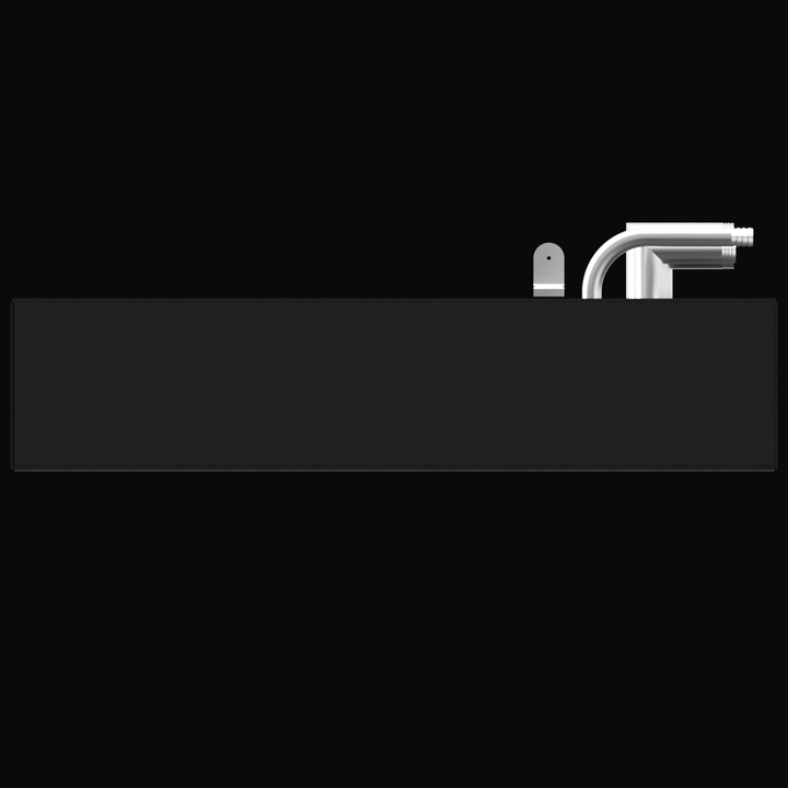 A straight-on side elevation view of a long, dark gray rectangular tank. Two metal fittings are visible on the top edge near the right side. The fitting on the left is a small, upright, rectangular piece with a rounded top and a small hole, while the fitting on the right is a large, curved, metallic pipe fitting with threads on the end. The tank is set against a black background.