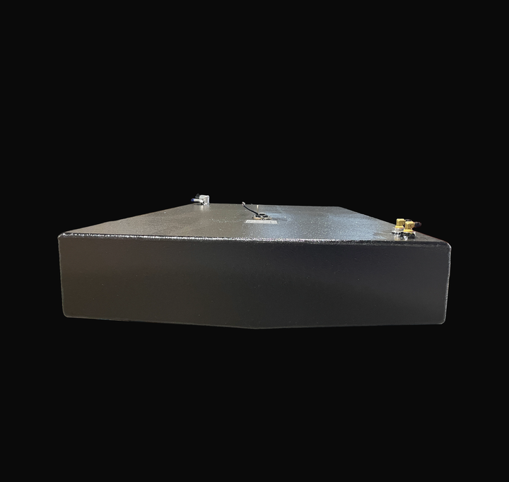 A studio low-angle end view highlighting the subtle V-bottom deadrise contour of a physical, finished black encapsulated Robalo 19 OEM replacement marine fuel tank (73 gal) from file image_281b2d.jpg, isolated against a black background. Precision-fabricated from heavy-gauge marine-grade 5052-H32 aluminum, the low-profile hull-conformed body is fully encapsulated in a protective, textured black TarGard epoxy coating to resist severe saltwater pitting and bilge moisture decay. Deck hardware includes right-fo
