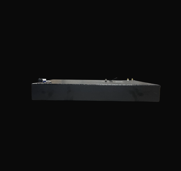 An eye-level studio side profile view displaying the slim 9-inch depth of a physical, finished black encapsulated Robalo 19 OEM replacement marine fuel tank (73 gal) from file image_280fcc.png, isolated against a black background. Precision-fabricated from heavy-gauge marine-grade 5052-H32 aluminum, the low-profile rectangular body is fully encapsulated in a protective, textured black TarGard epoxy coating to resist severe saltwater pitting and bilge moisture decay. Top deck hardware features a left-side fu