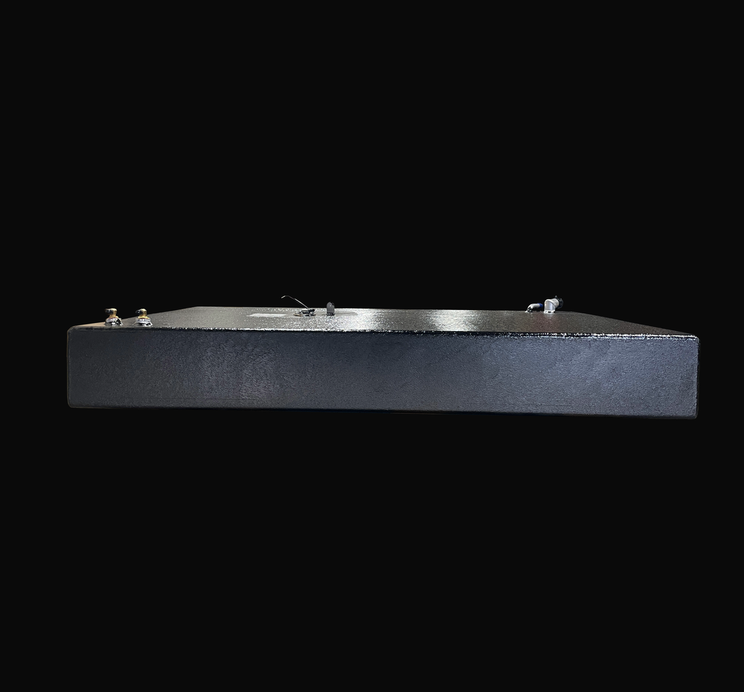 An eye-level studio side profile view displaying the opposite full length of a physical, finished black encapsulated Robalo 19 OEM replacement marine fuel tank (73 gal) from file image_28136f.jpg, isolated against a black background. Precision-fabricated from heavy-gauge marine-grade 5052-H32 aluminum, the slim 9-inch low-profile rectangular body is fully encapsulated in a protective, textured black TarGard epoxy coating to resist severe saltwater pitting and bilge moisture decay. Top deck hardware configur
