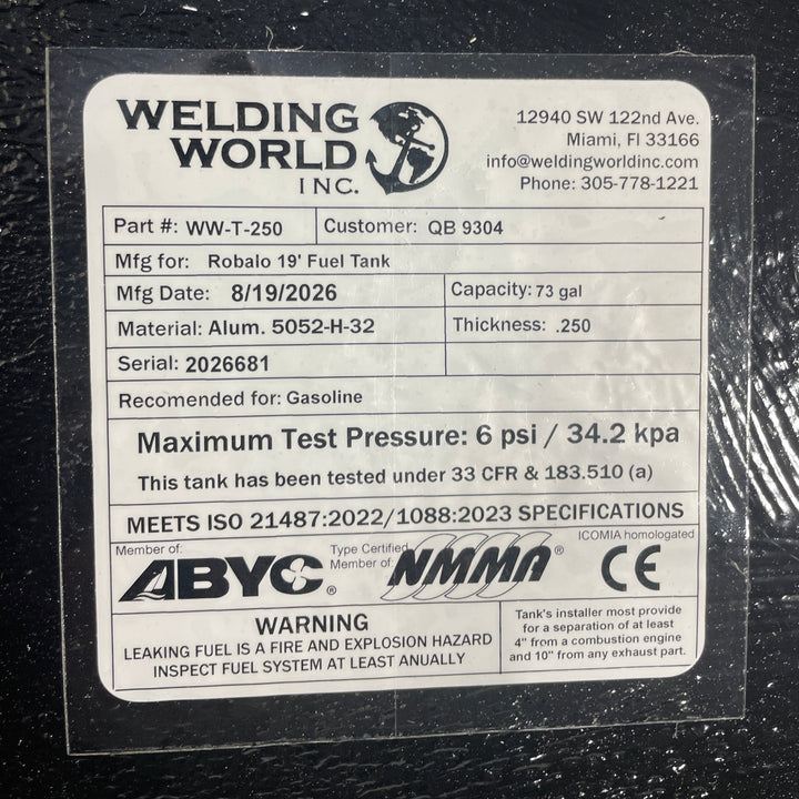A close-up studio detail view of the official manufacturer specification and compliance certification tag applied directly to the textured black TarGard epoxy coating of a finished Robalo 19 OEM replacement marine fuel tank (73 gal) from file image_281e14.jpg. Certified by Welding World Inc. in Miami, FL, the spec plate certifies part number WW-T-250, serial number 2026681, heavy-duty .250-thickness marine-grade Alum. 5052-H-32 construction, gasoline compatibility, 6 psi / 34.2 kPa maximum pressure testing 