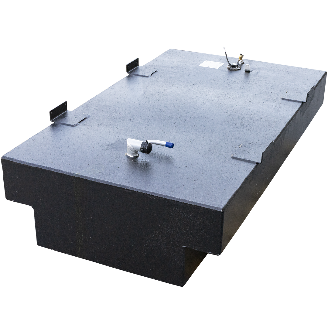A black, rectangular fuel tank with a textured surface, viewed from above and at an angle. It has a recessed section along its lower front edge. On its top surface, there is a white L-shaped pipe with a blue tip on the right side, and a circular fitting with several smaller pipes and wires on the left side. Several metal brackets are also attached to the top edges of the tank