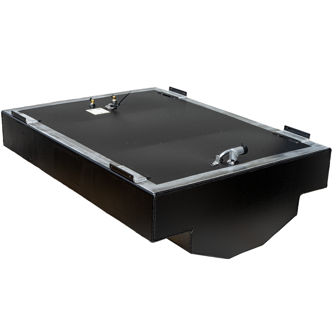 A black, rectangular fuel tank with a textured surface and a metallic frame around its top edge. Various fittings, including a fuel sender and a hose connection, are visible on the top surface. The tank has a stepped cut-out on its bottom left and right sides