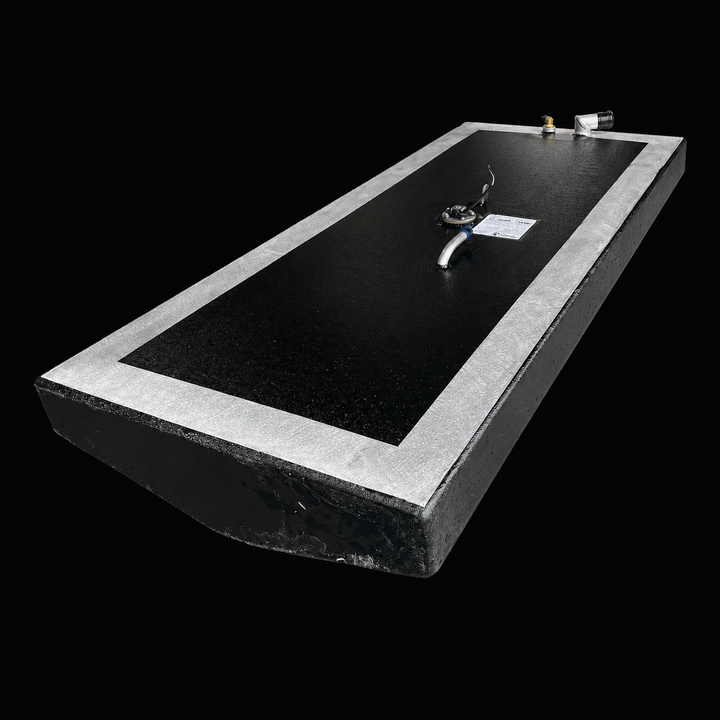 A low-angle isometric perspective view from the opposite end of a low-profile rectangular black Scout 16 replacement marine fuel tank. This 32-gallon capacity center-hull fuel cell is precision-fabricated by Welding World from heavy-gauge marine-grade 5052-H32 aluminum, highlighting its low-profile angled bottom profile designed to seat flush within the boat's central bilge cavity. The main body surfaces are coated in a protective, anti-corrosive, textured black TarGard epoxy finish while showing a bare sil