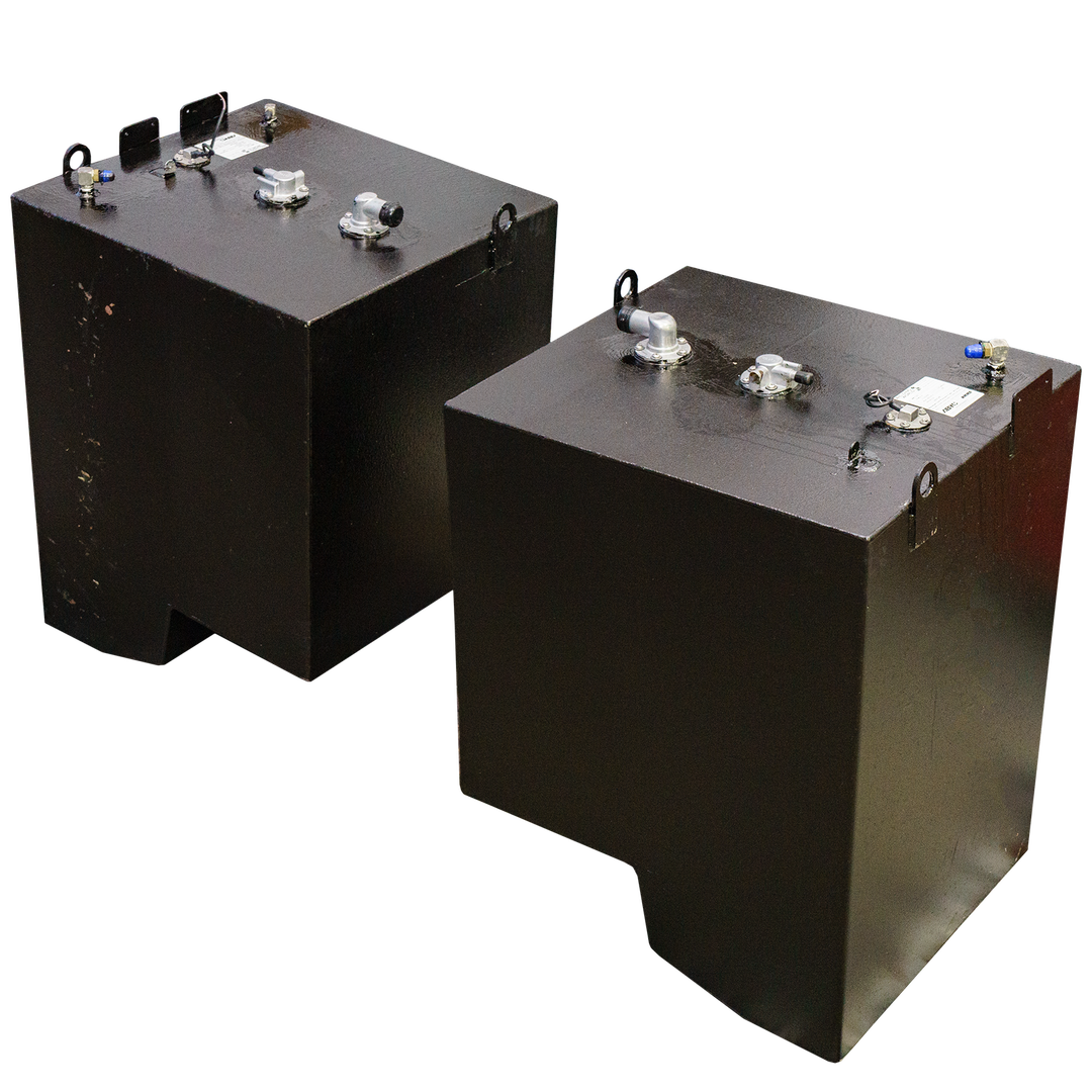 Two dark metal industrial fuel tanks with various fittings, caps, handles, and lifting loops on top, positioned side by side on a transparent checkered background. Each tank features visible labels and unique metal components, designed for OEM replacement purposes.