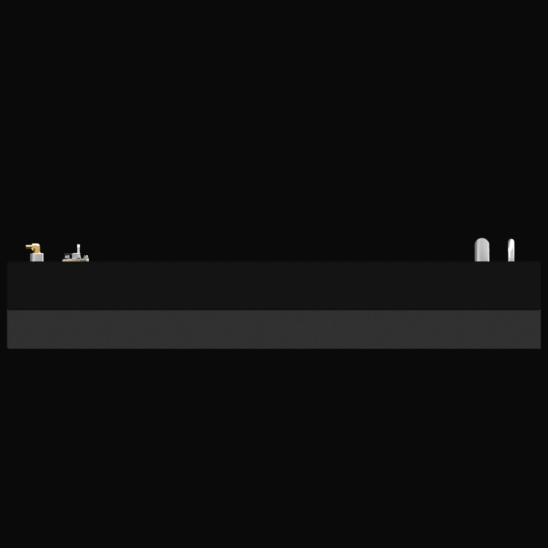 A black background with a gray rectangular panel featuring various small fittings, valves, and pipes on top, including a gold-colored faucet on the left and two white pipes on the right