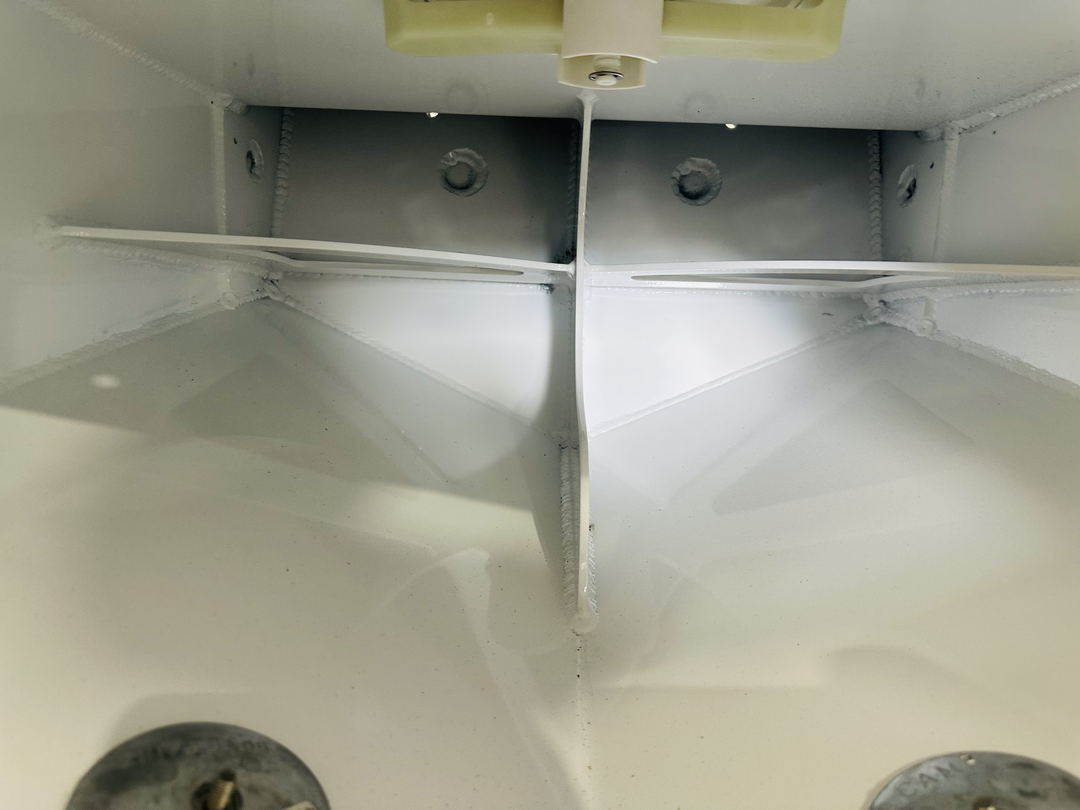 Interior view of a 1977 Seacraft 23 enclosed transom, showcasing the high flotation single engine bracket with visible welds and mounting holes