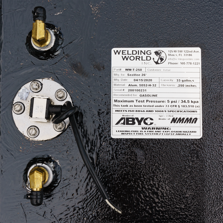 Close-up of a SeaVee 26' 2-Tank Combo fuel tank kit featuring a 100-gallon and a 33-gallon tank. The image shows the fuel tank's connection points, a label with manufacturing details, and a warning about maximum test pressure. The label includes the model number, manufacturing date, and specifications for gasoline use