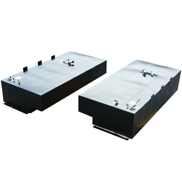 Two rectangular black fuel tanks, one with a stepped bottom, both featuring various fittings on their textured top surfaces, against a checkered background