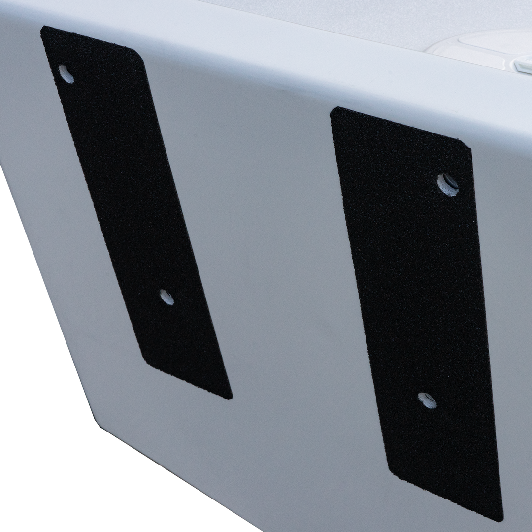 A close-up of a white transom with two black mounting brackets attached vertically. The brackets are rectangular with rounded edges and each has two holes for mounting. The background is transparent