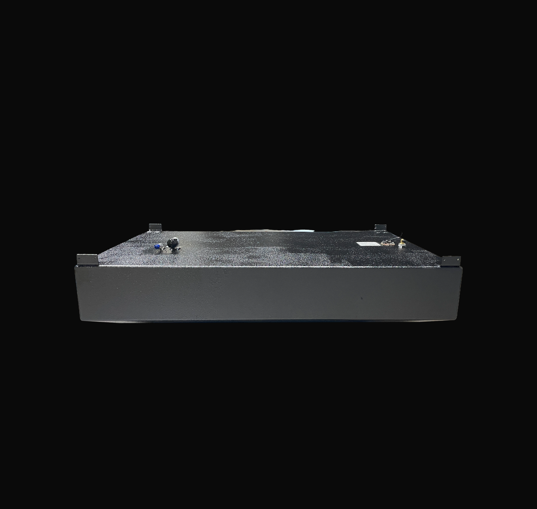 An eye-level studio side profile view displaying the opposite full length of a physical, finished black encapsulated WellCraft 23.8 CCF 1994 OEM replacement marine fuel tank (137 gal) from file image_5c7de1.jpg, isolated against a black background. Precision-fabricated from heavy-gauge marine-grade 5052-H32 aluminum, the low-profile hull-contoured body is fully encapsulated in a protective, textured black TarGard epoxy coating to resist severe saltwater pitting and bilge moisture decay. Top deck hardware fe