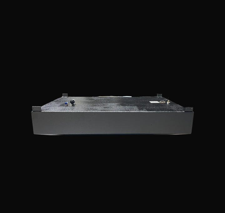 An eye-level studio side profile view displaying the opposite full length of a physical, finished black encapsulated WellCraft 23.8 CCF 1994 OEM replacement marine fuel tank (137 gal) from file image_5c7de1.jpg, isolated against a black background. Precision-fabricated from heavy-gauge marine-grade 5052-H32 aluminum, the low-profile hull-contoured body is fully encapsulated in a protective, textured black TarGard epoxy coating to resist severe saltwater pitting and bilge moisture decay. Top deck hardware fe