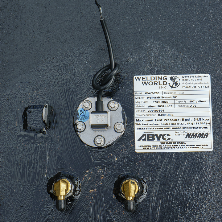 OEM replacement fuel tank for a 30-foot Wellcraft Scarab boat, featuring a 197-gallon capacity. The tank includes a fuel sender unit and two brass fittings, with a label detailing specifications and warnings
