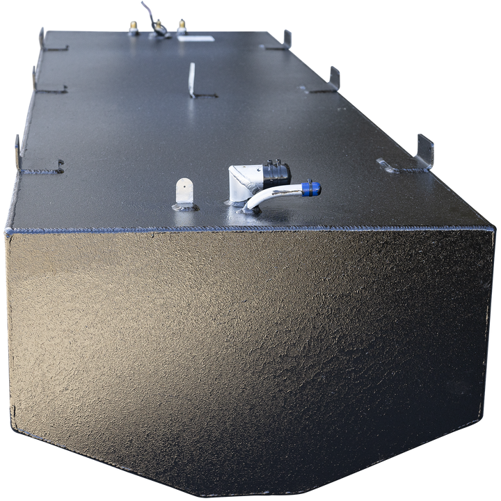 Large black metal fuel tank with visible weld seams and several mounting tabs along the top and side edges. The tank has a rounded front edge and multiple metal fittings on the top surface, including a curved white pipe with a blue cap and a black connector. The background is transparent, focusing on the tank from an angled front perspective
