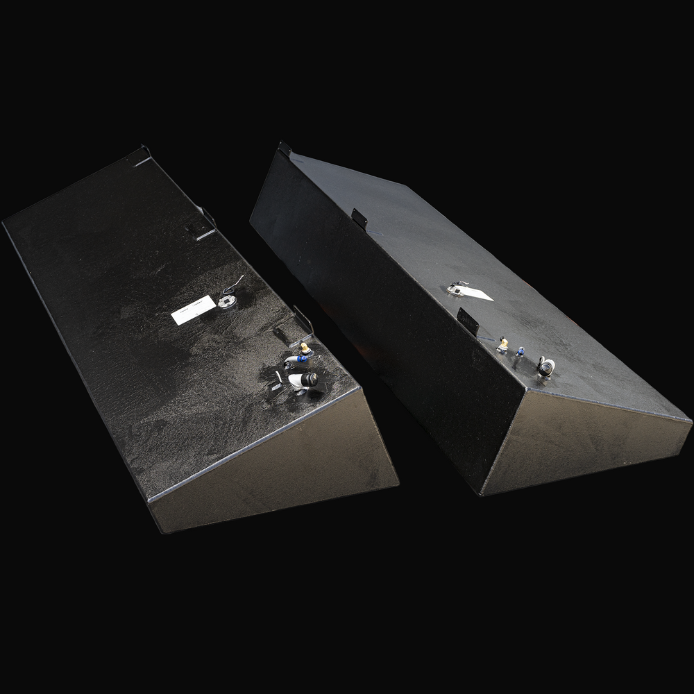 Two black marine fuel tanks side by side with angled ends and multiple fittings on top. Each tank has a white label and mounting brackets. Described as Advanced 33 model with 128 gallons net capacity each, an OEM replacement saddle fuel tank combo